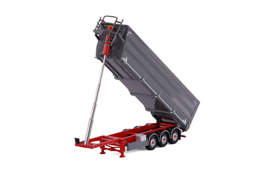 A miniature toy dump truck trailer, likely a scale model, featuring a gray tipping dump body and a red chassis with a silver support arm, shown on a white background.